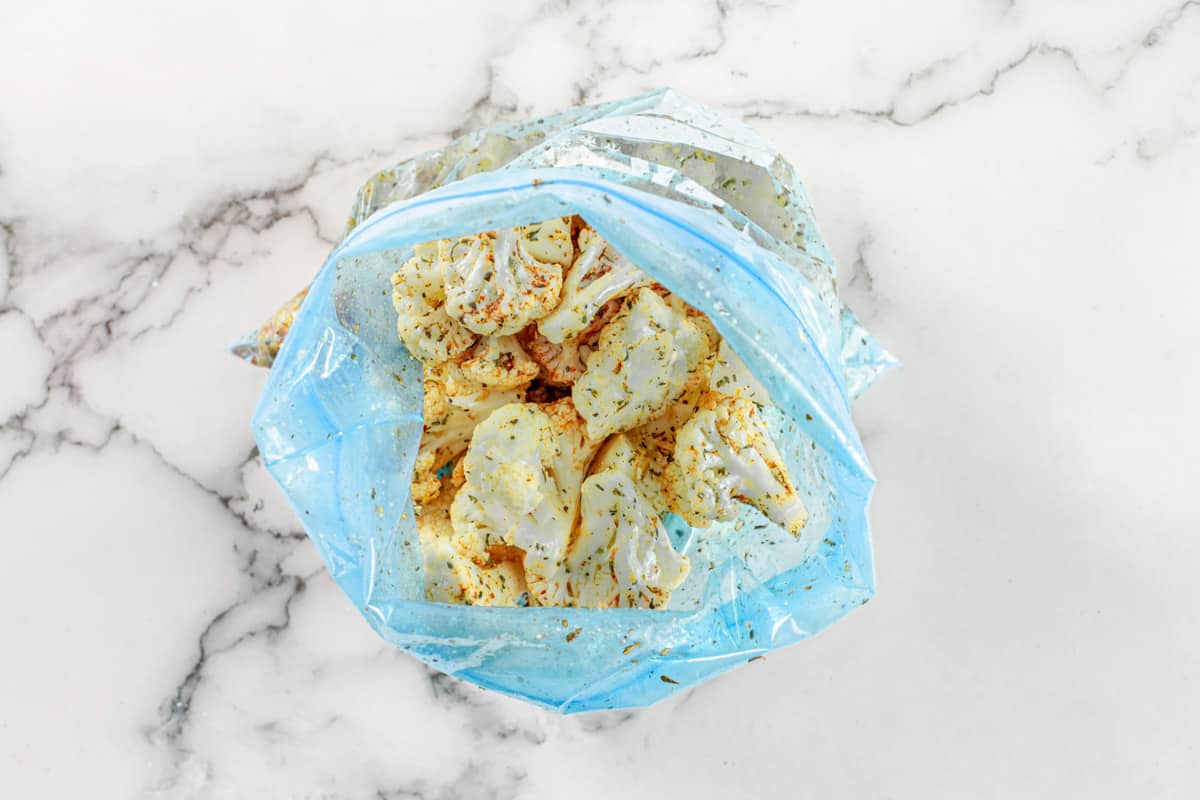 cauliflower in a plastic bag with seasonings