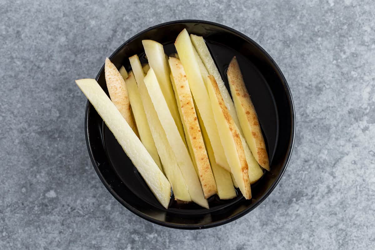 potato fries soaking in water before air frying