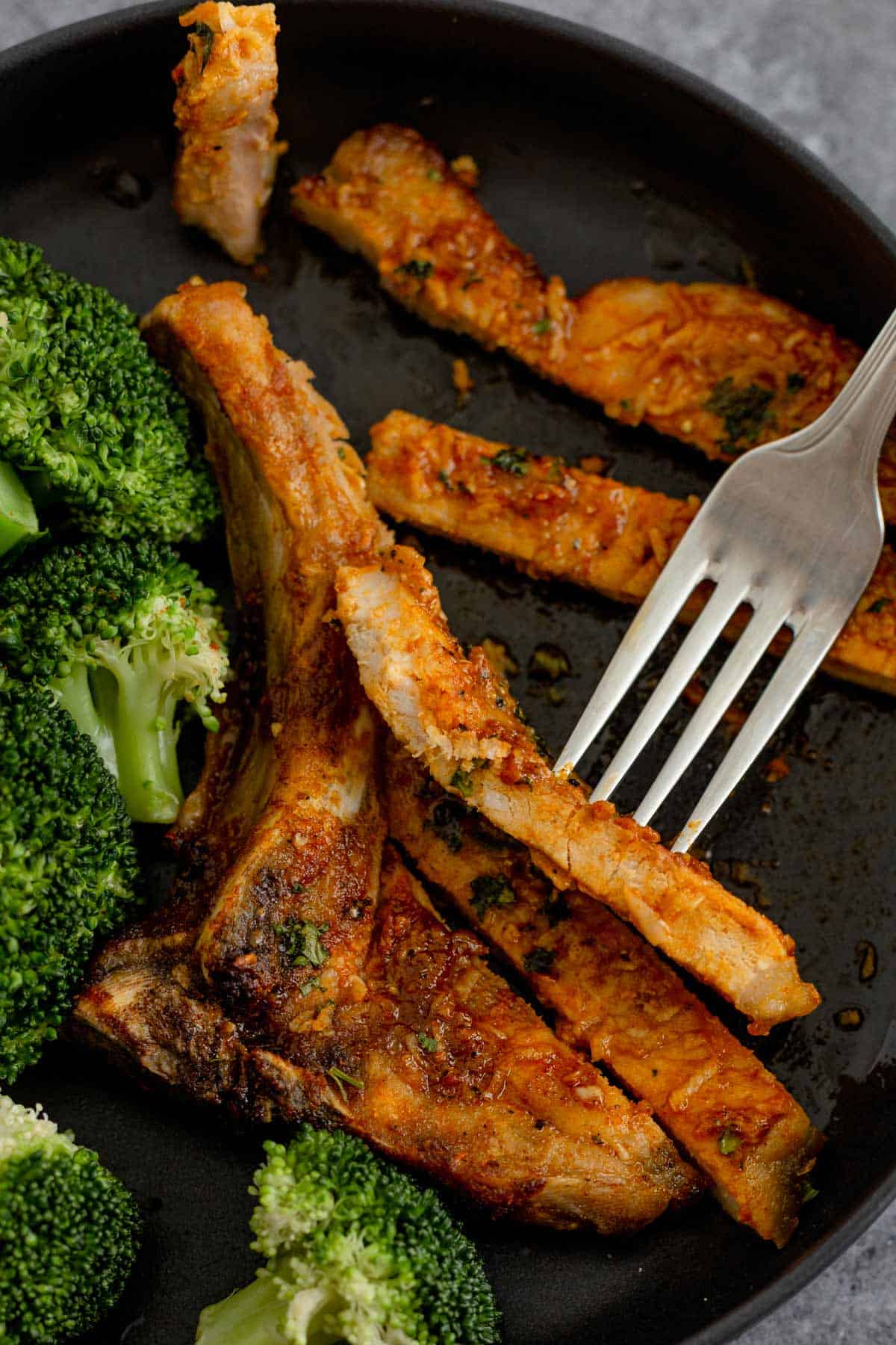 sliced cooked air fryer bone in pork chops on a plate