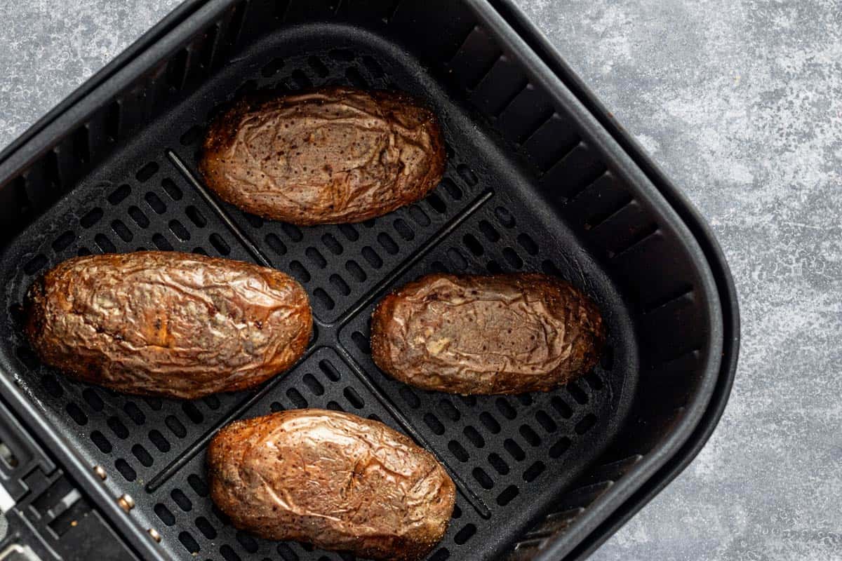 skin side up potato skins in the air fryer basket.