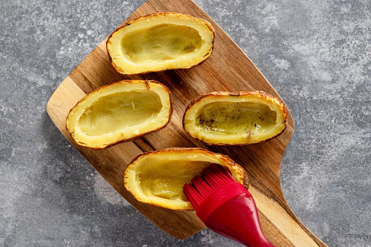 brushing the insides of the potato skins with olive oil.