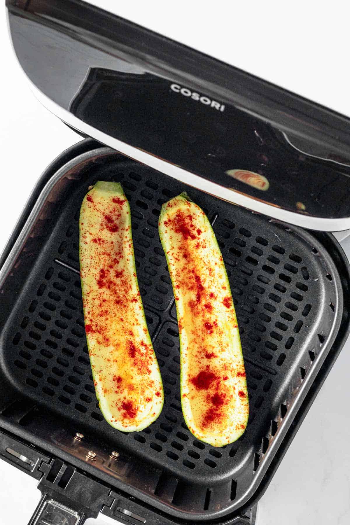 seasoned zucchini halves in air fryer