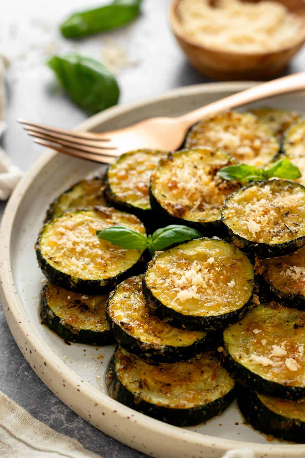 garnished with basil slices of zucchini in a serving bowl.