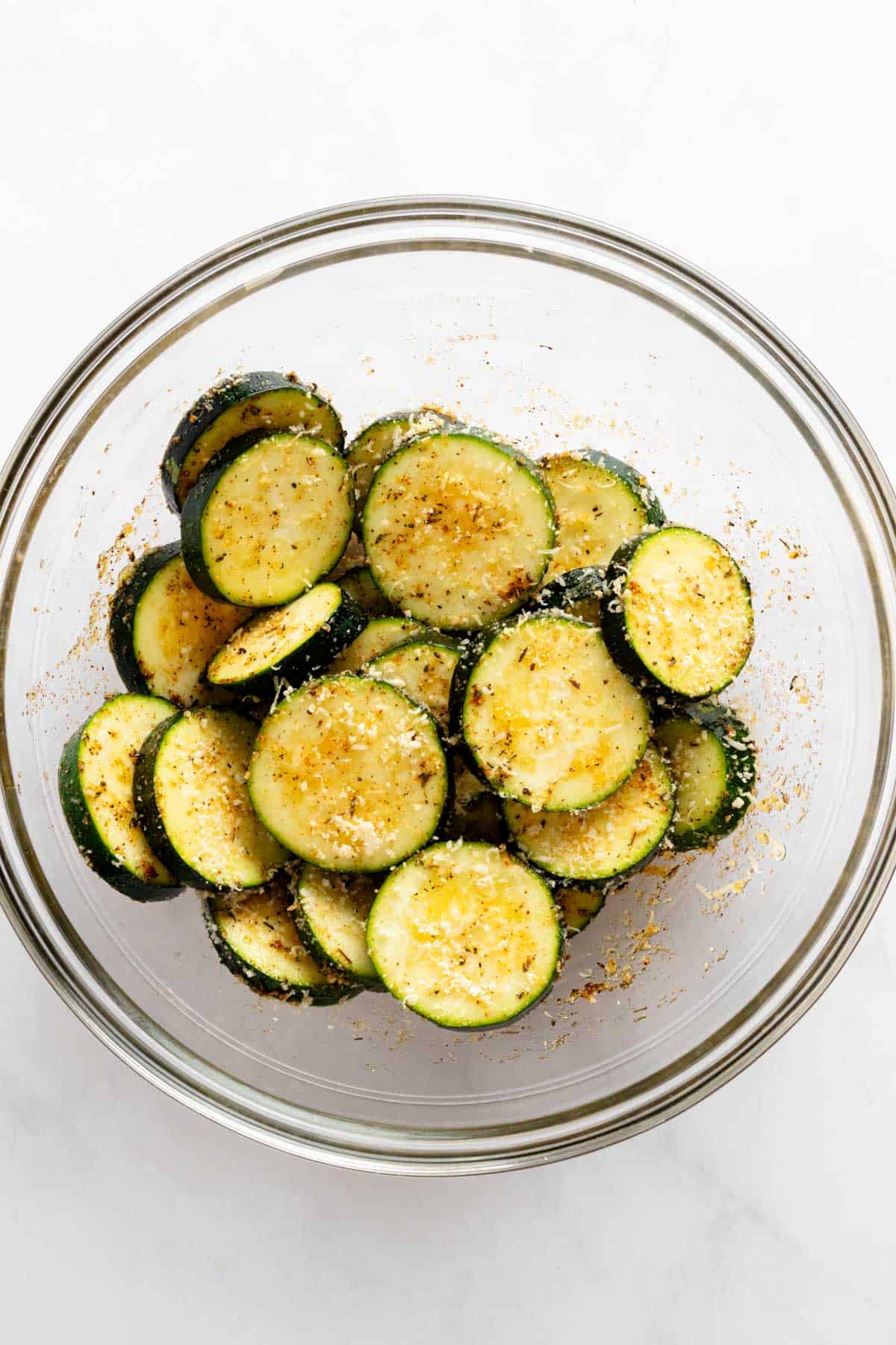 seasoned zucchini slices in a bowl.