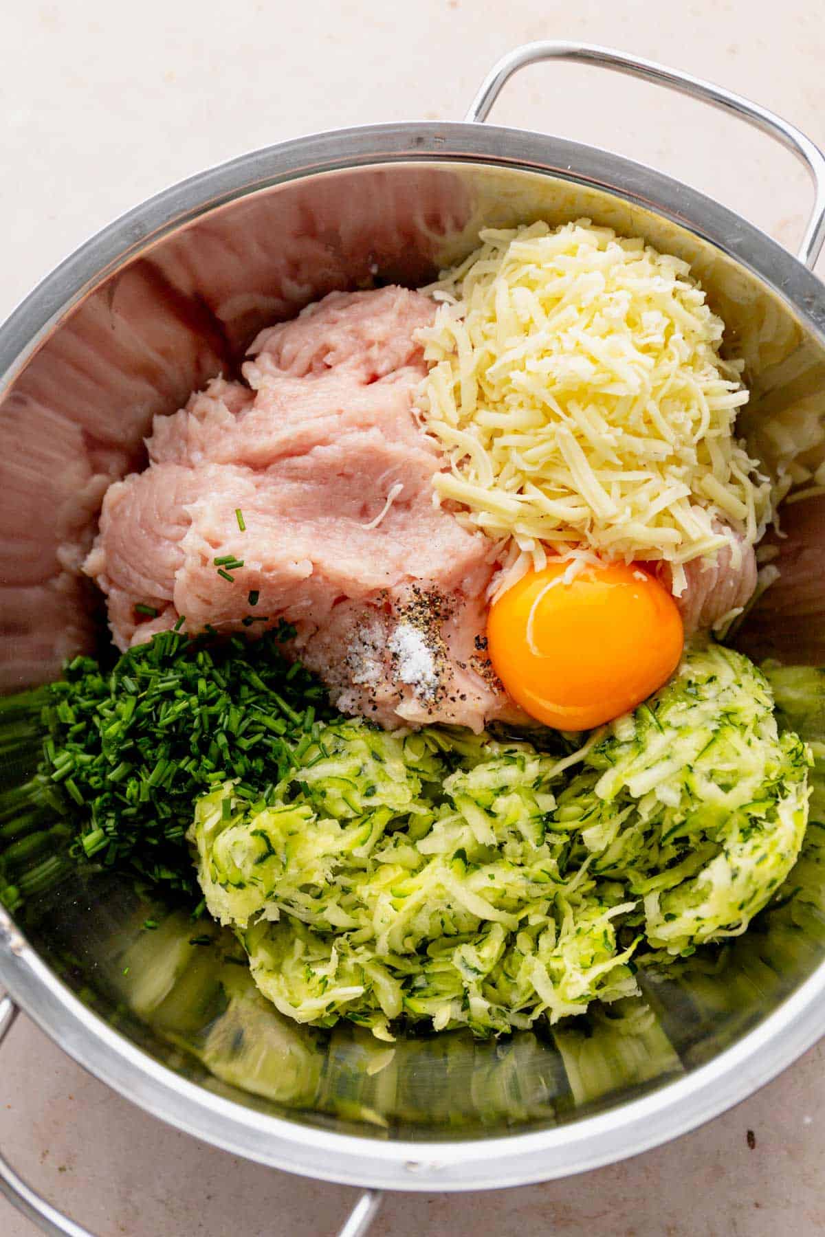 chicken fritters ingredients in a bowl.