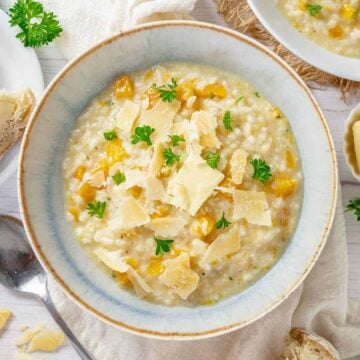 top shot of a pumpkin risotto in a light blue bowl