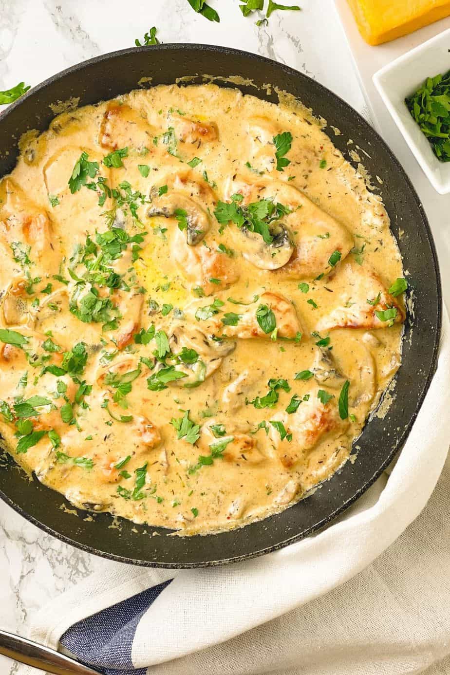 Chicken smothered in a rich and creamy cheddar sauce with parsley is a truly heartwarming , so cozy and a perfect dinner meal. Very quick and easy dinner recipe idea to make from scratch which only takes you 30 minutes to make.- The Yummy Bowl