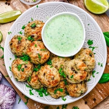 These baked Cheesy Summer Squash Zucchini Bites are easy, super flavorful and a great meal prep idea for a weekday dinner night. They are loaded with summer squash zucchini, garlic, mushrooms and two types of cheese - blue cheese and parmesan cheese. All this yumminess is served with a creamy avocado yogurt dressing for a mind-blowing culinary experience! - The Yummy Bowl