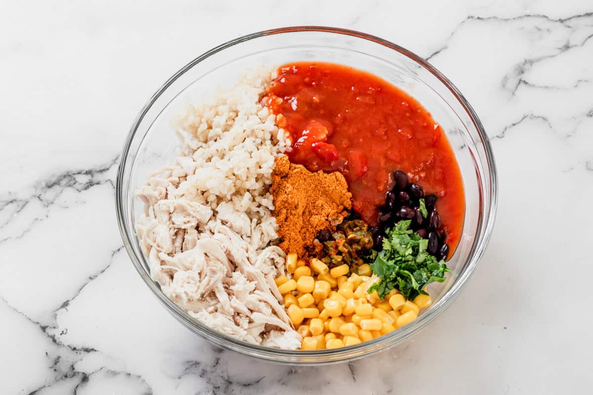 chicken enchilada stuffing ingredients mixture in a mixing bowl