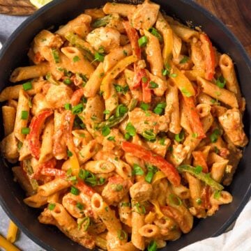 Chicken Fajita Pasta in skillet with herbs