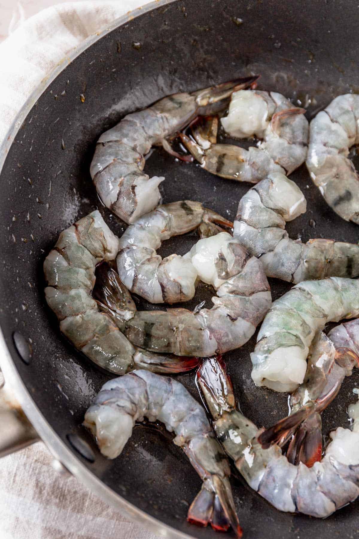 raw shrimp in skillet