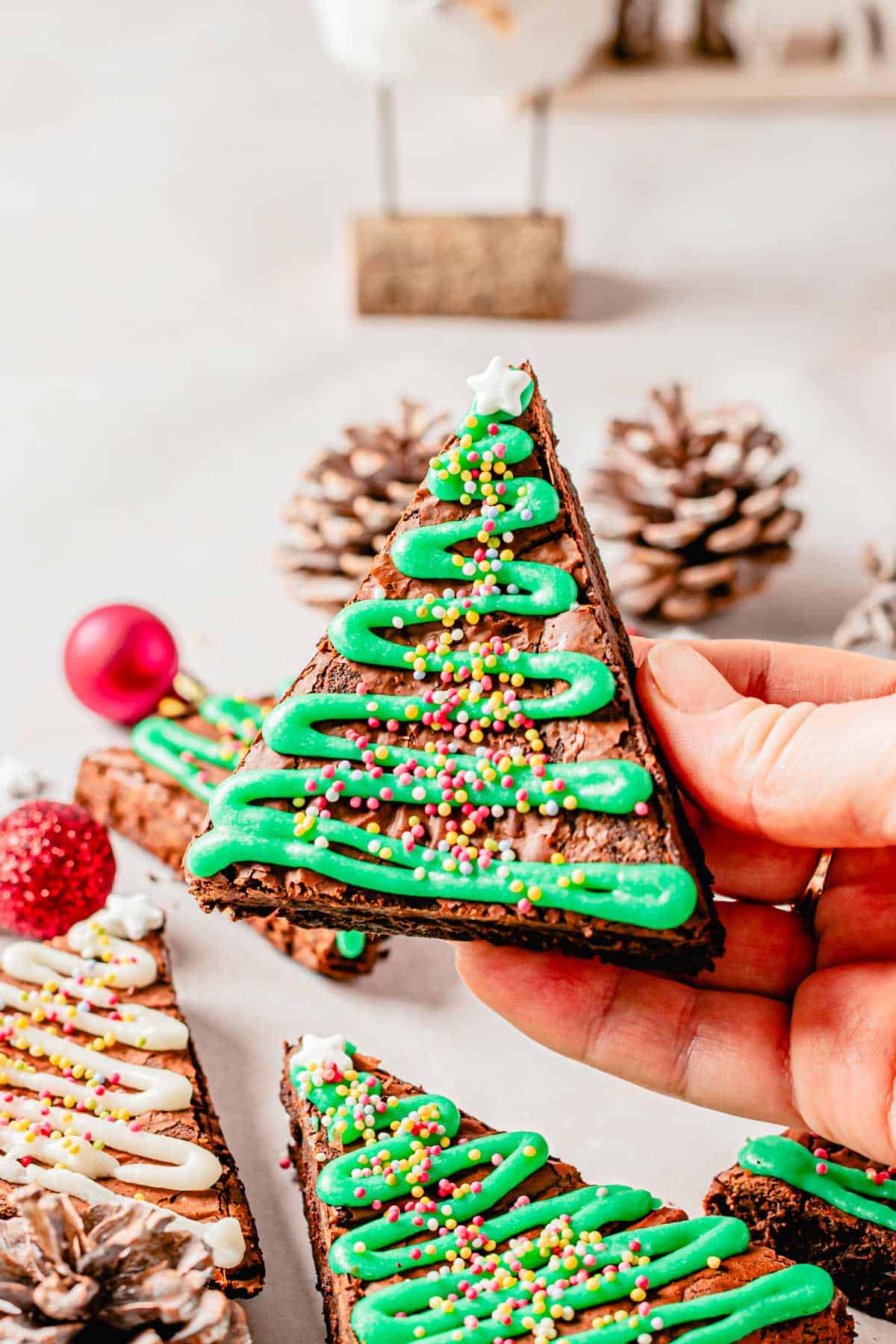 christmas tree brownies with green powdered sugar glaze and sprinkles