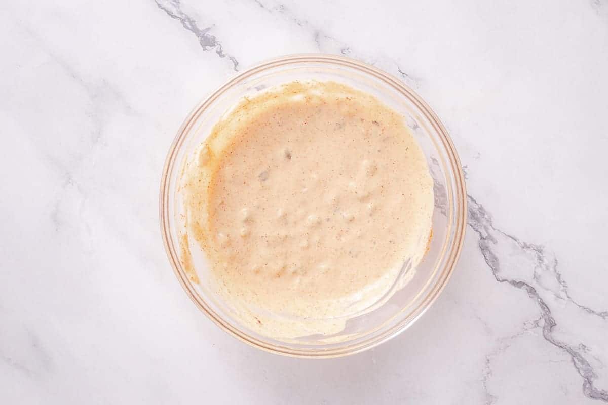 creamy paprika sauce mixed in a bowl over marble background