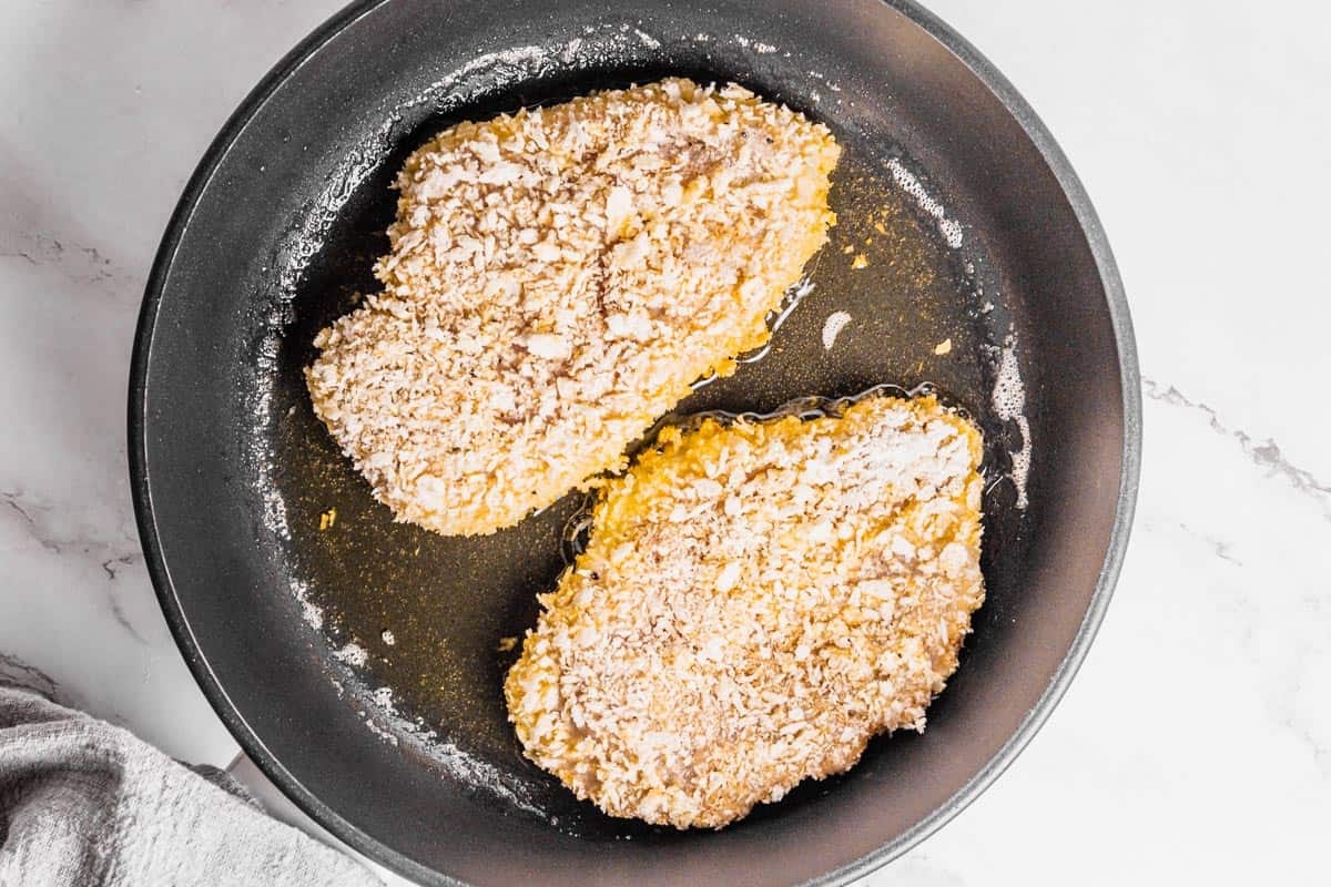 panko chicken filets frying in pan