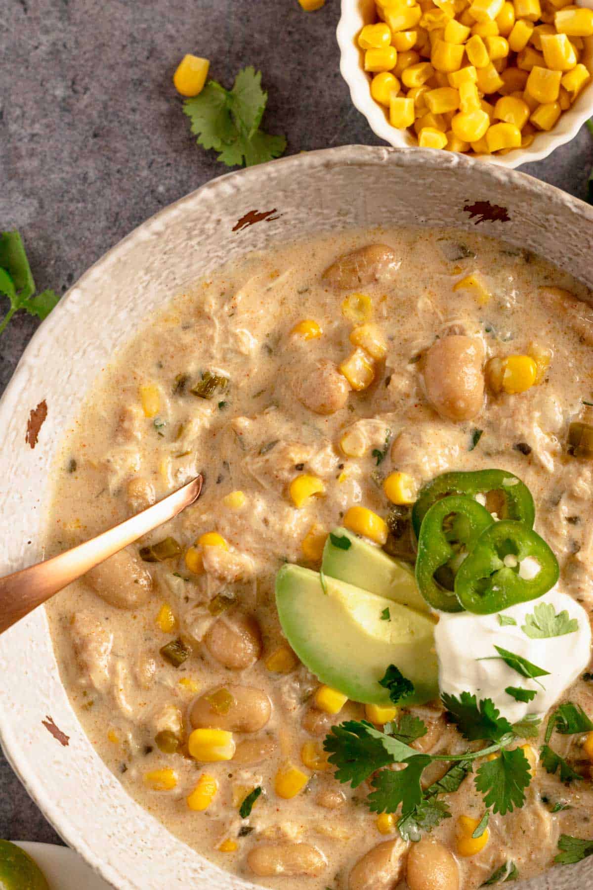 Crock Pot Chicken Chili Cream Cheese with doritos and cilantro, avocado