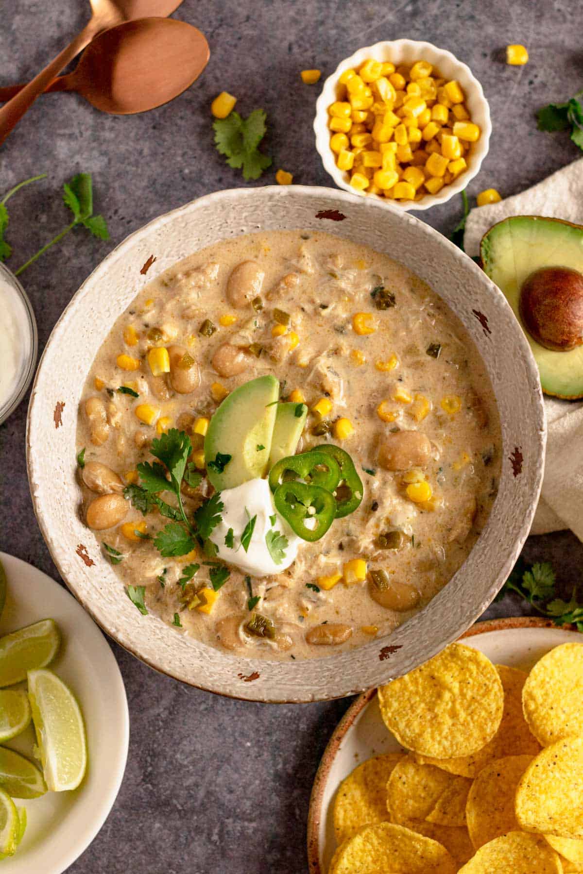 Crock Pot Chicken Chili Cream Cheese with doritos and cilantro, avocado