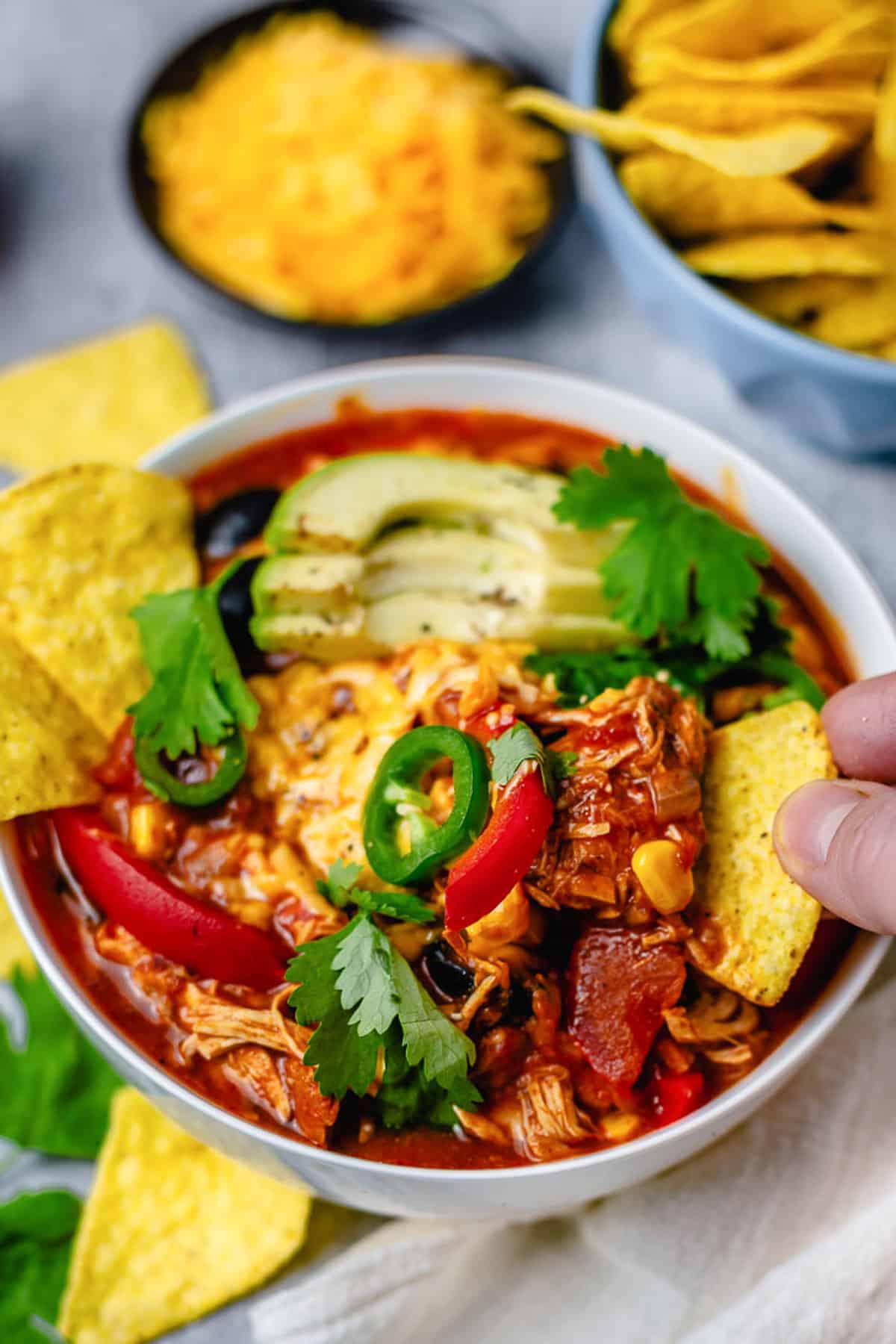 chicken enchilada in a bowl with avocado jalapeno tortilla chips