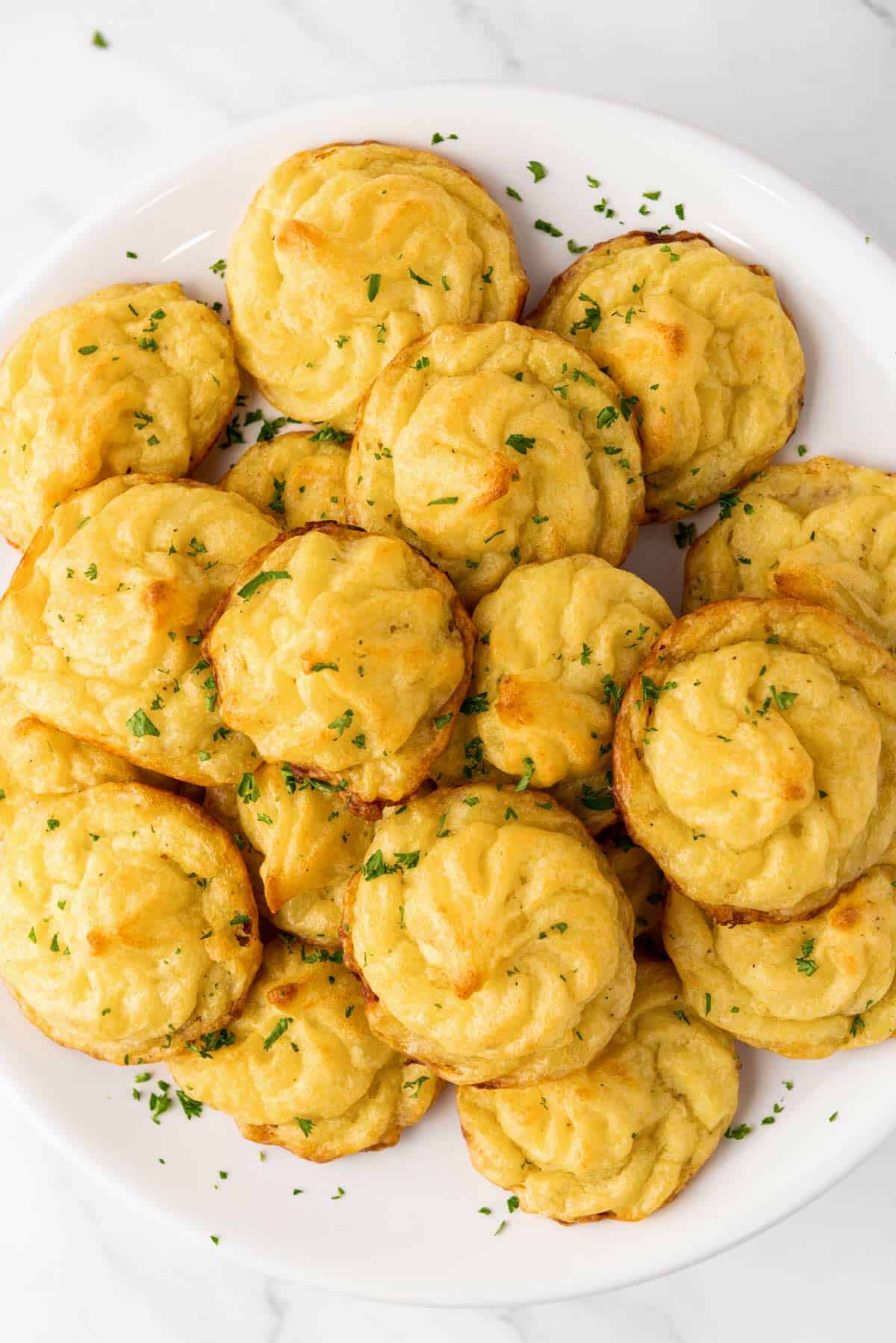 a stack of duchess potatoes on a plate