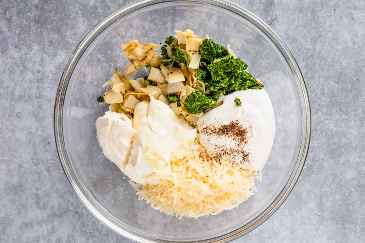 ingredients for spinach artichoke in a bowl