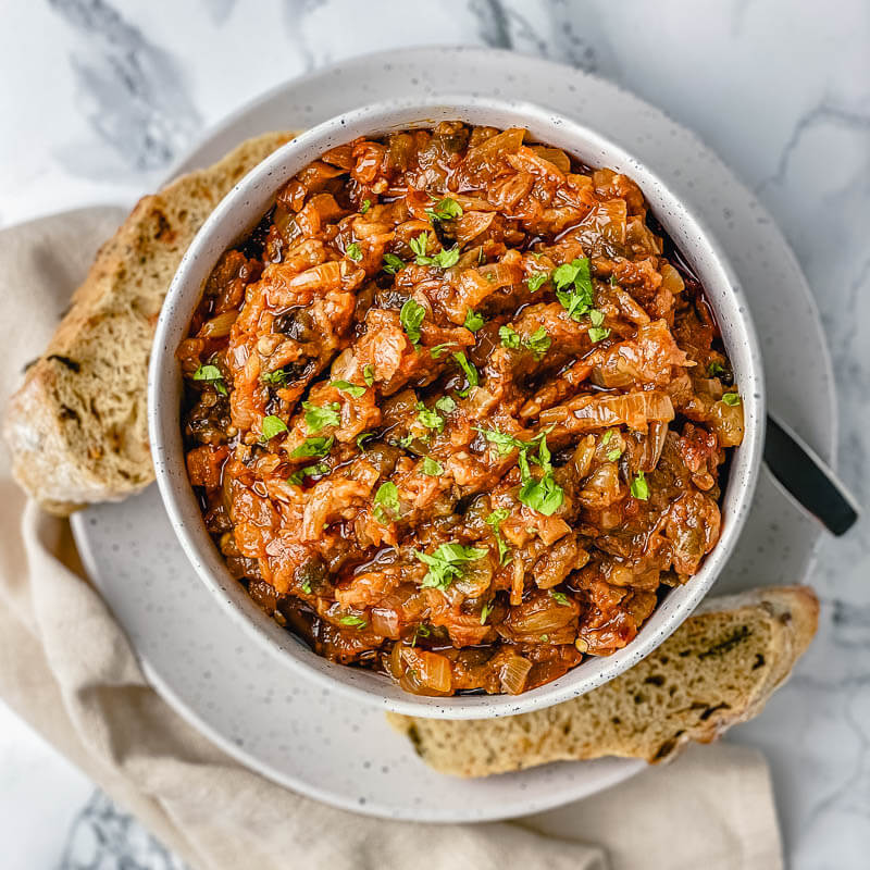 Terrific smoky eggplant caviar spread/dip! Perfect to spread over crackers for an easy, healthy, delicious appetizer. #eggplantcaviar #eggplantdip #eggplantcaviarrussian #eggplantspread #roastedeggplantspread #veganeggplantspread