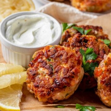 Fried Salmon Patties on a serving plate with parsley