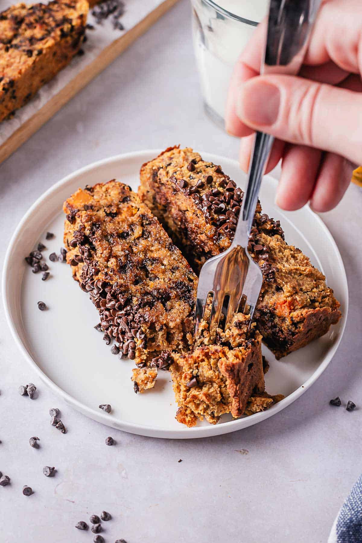 fork taking a piece out of pumpkin bread slice