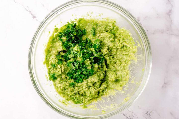 Simple Guacamole recipe process shots - mashed avocado with cilantro