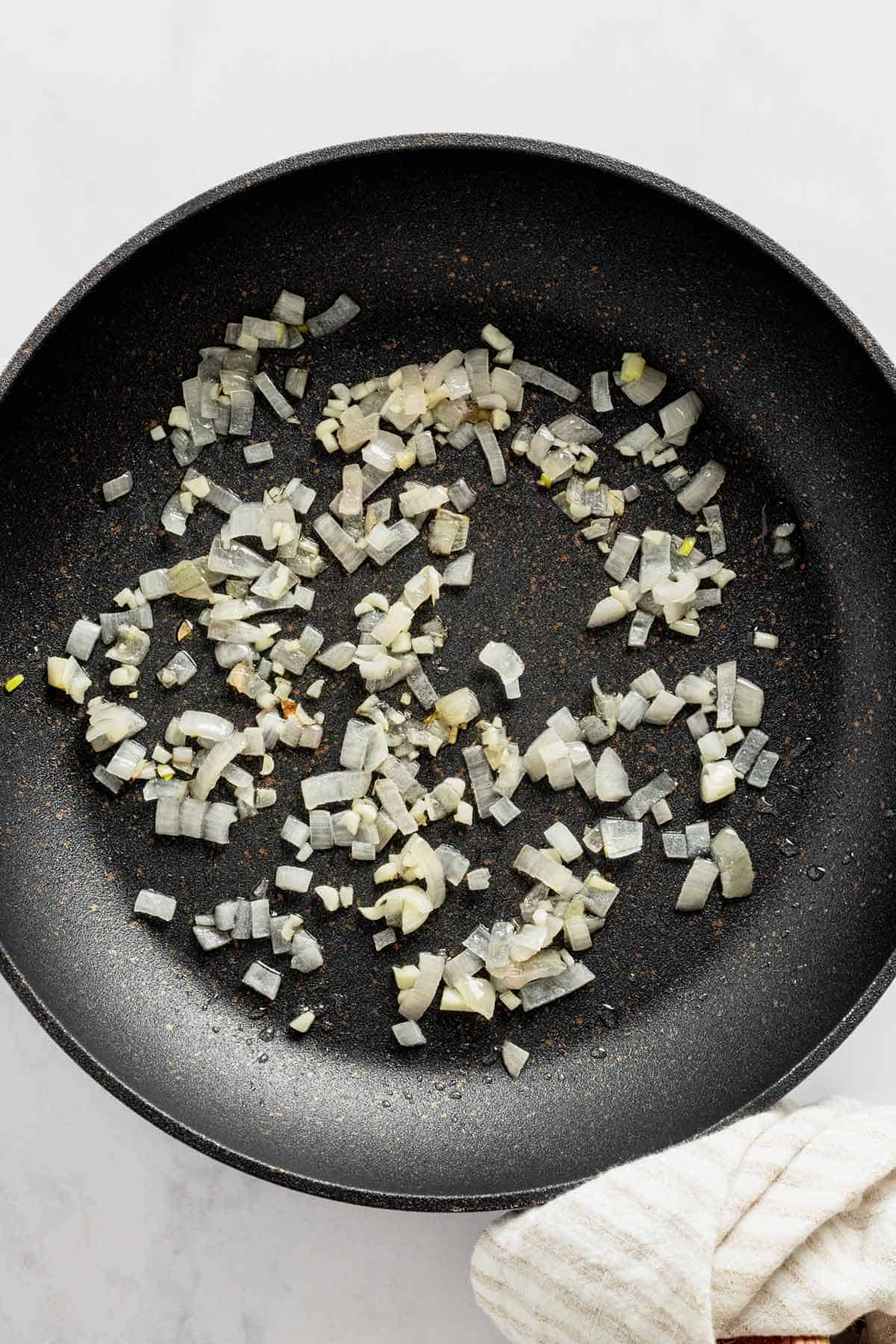 sauteing onions in a pan.