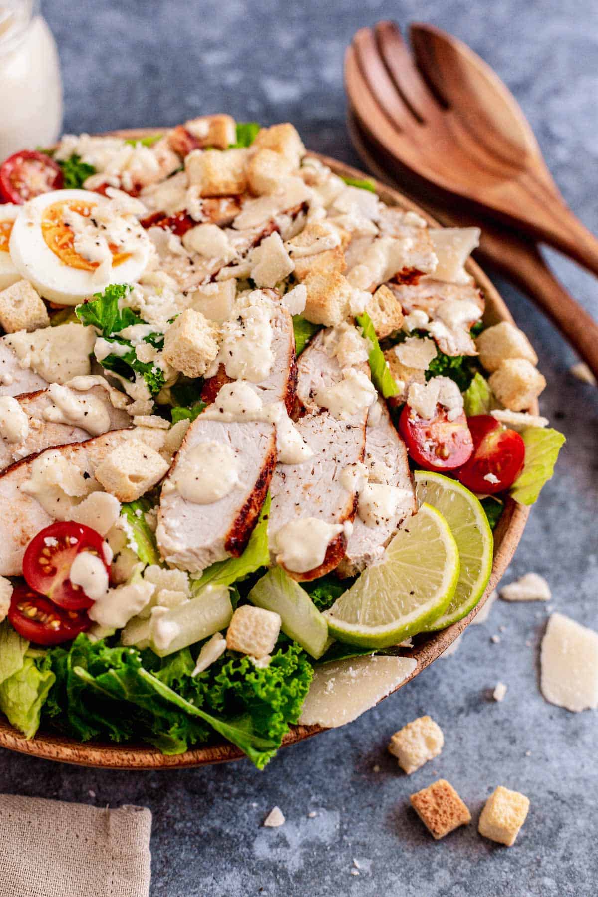 Lemon Kale Caesar Salad with chicken in a white bowl