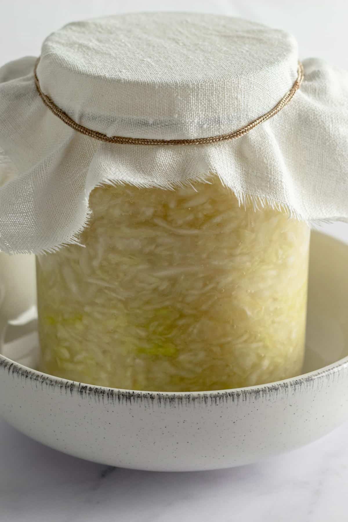 sauerkraut jar with a towel on top instead of a lid.