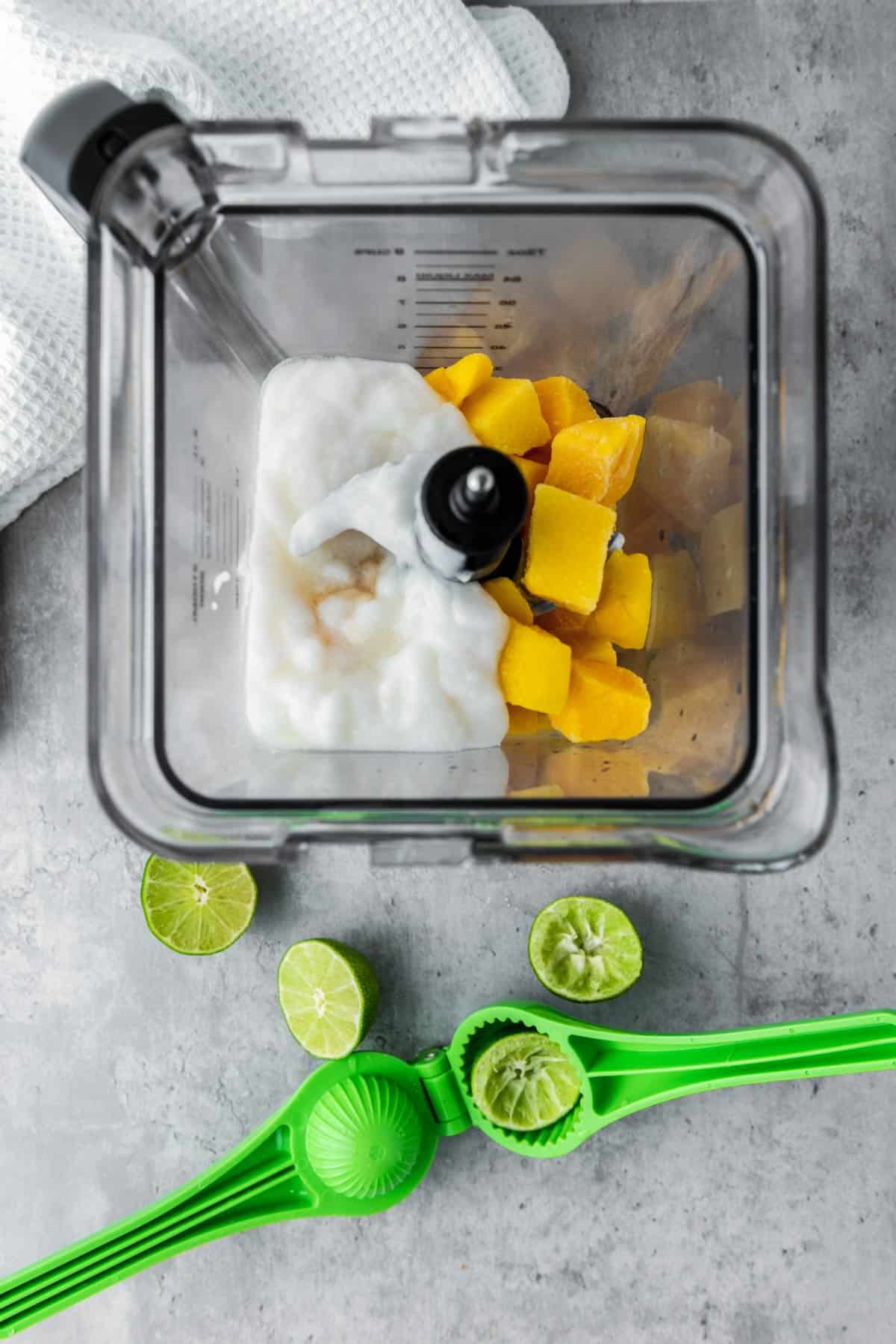 coconut yogurt and mangoes and lime juice in food processor before blending