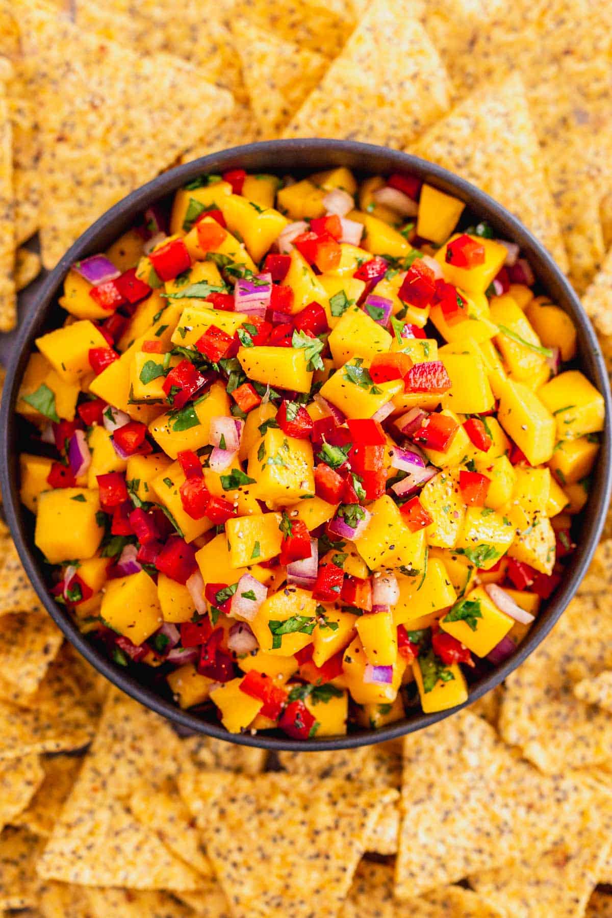 mango salsa with spicy peppers in white bowl