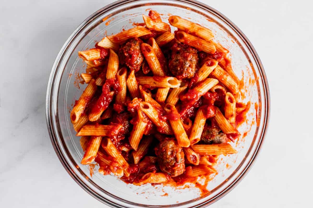 ziti pasta mixed with marinara sauce.