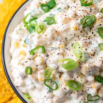 a bowl of mexican corn dip with sour cream