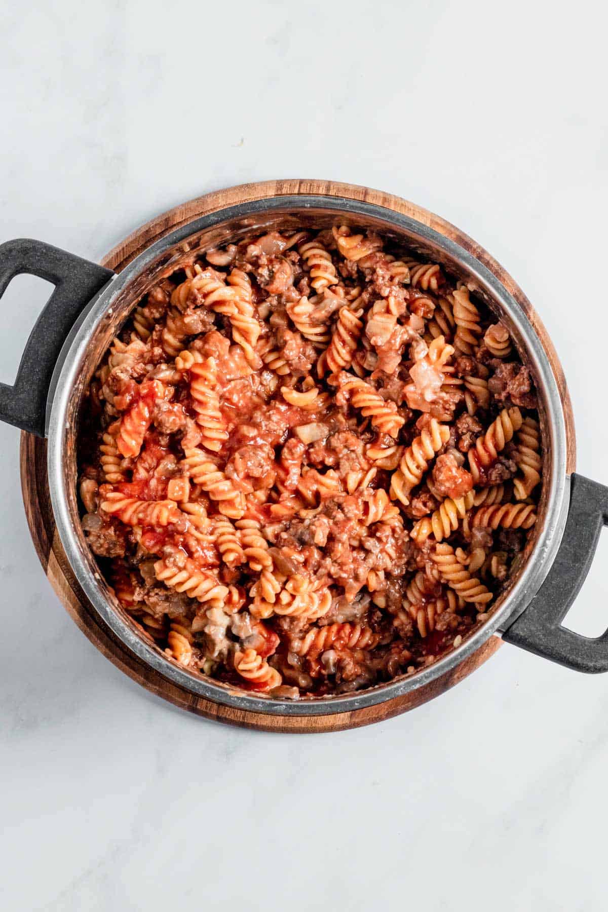 sauces added to pasta in a pot