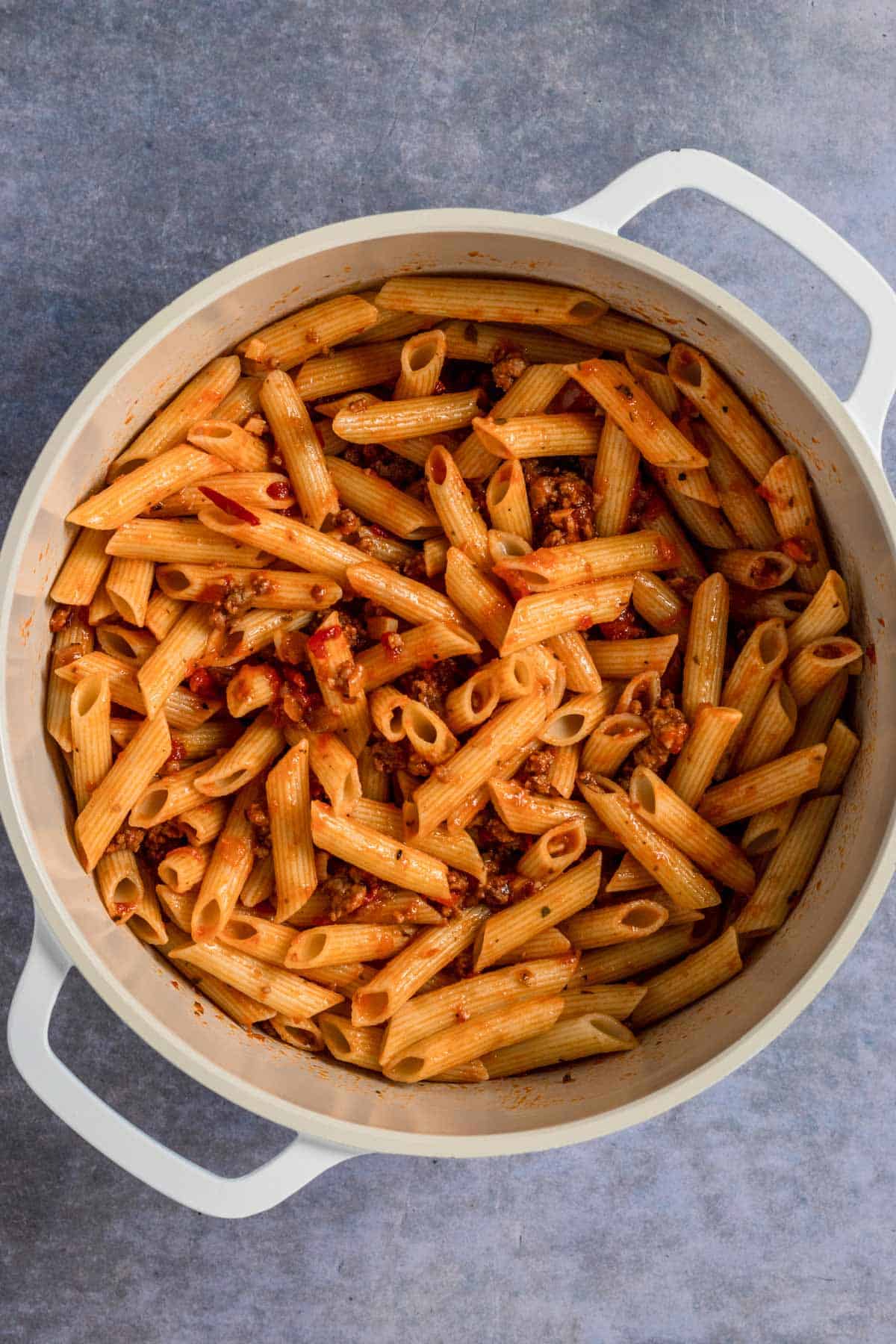 pasta mixed with red sauce in a pot