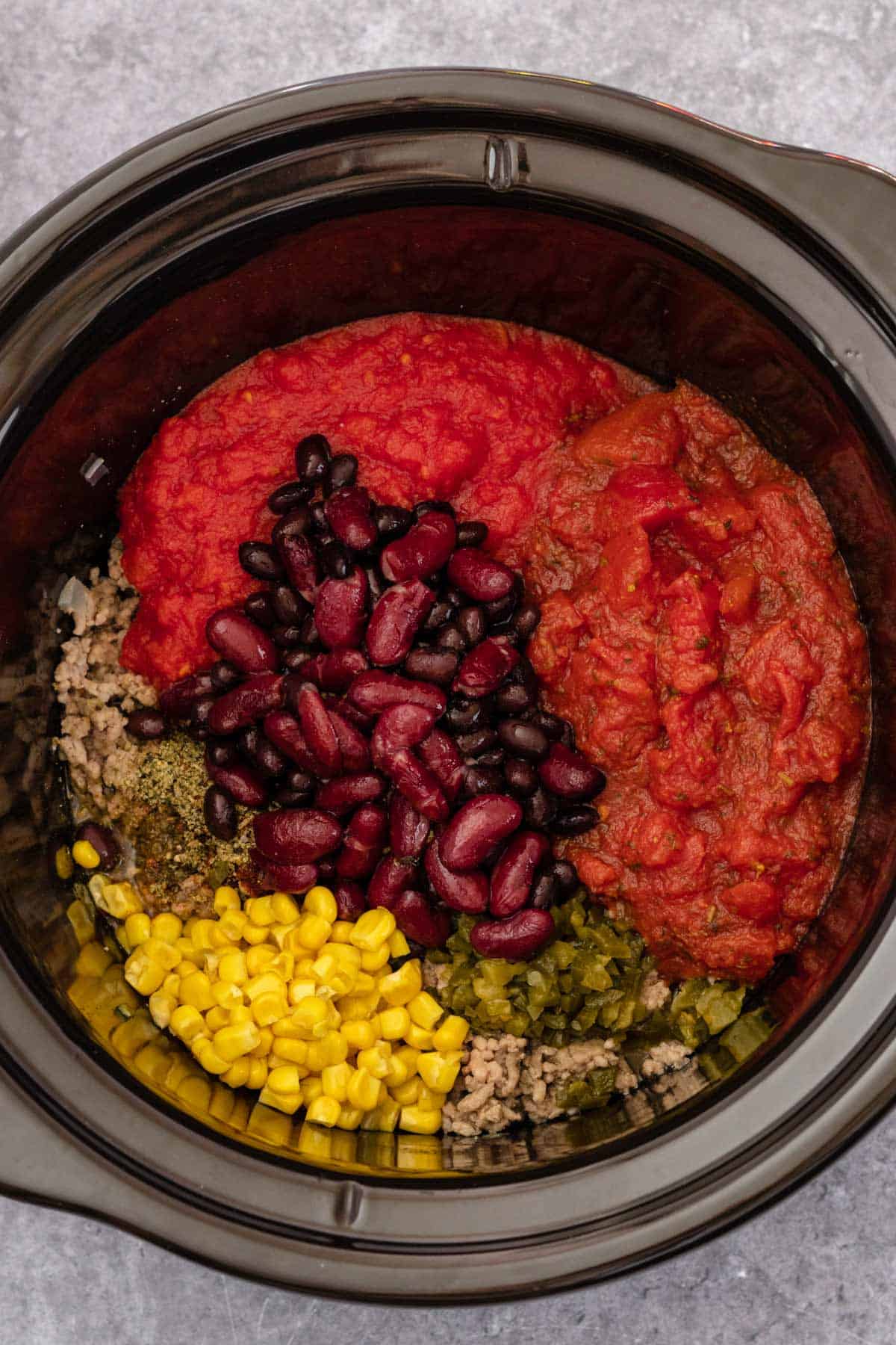 beef taco soup ingredients in slow cooker before cooking