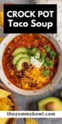 slow cooker taco soup with beef in bowl with toppings