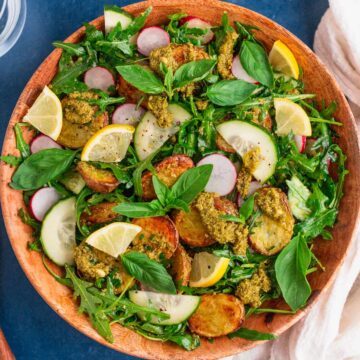 pesto potato salad in a wooden bowl