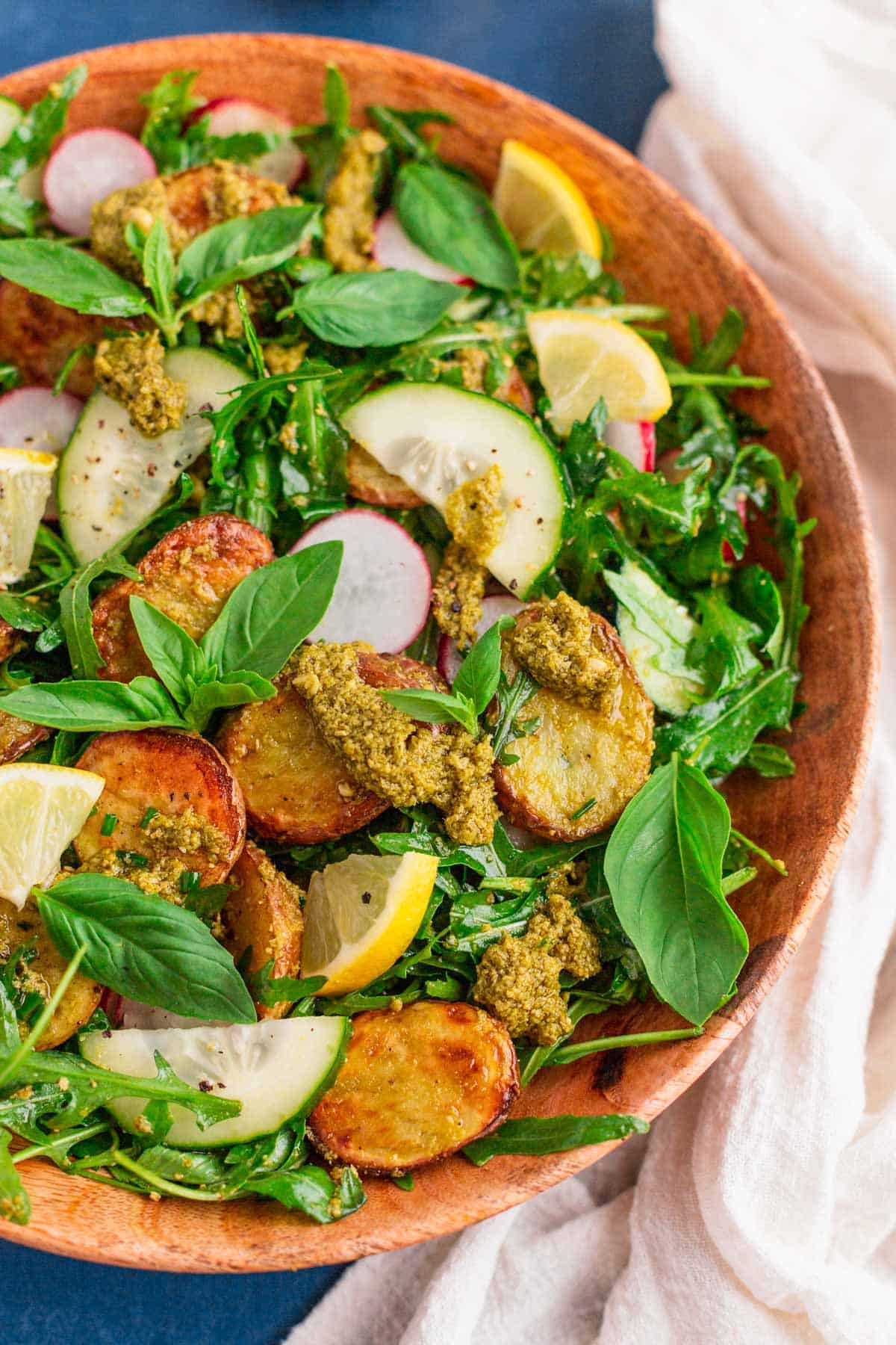 pesto potato salad in a wooden bowl