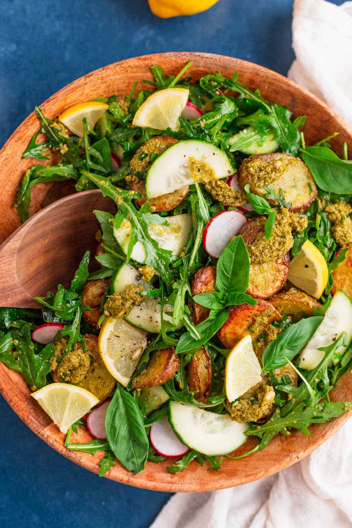 pesto potato salad in a wooden bowl