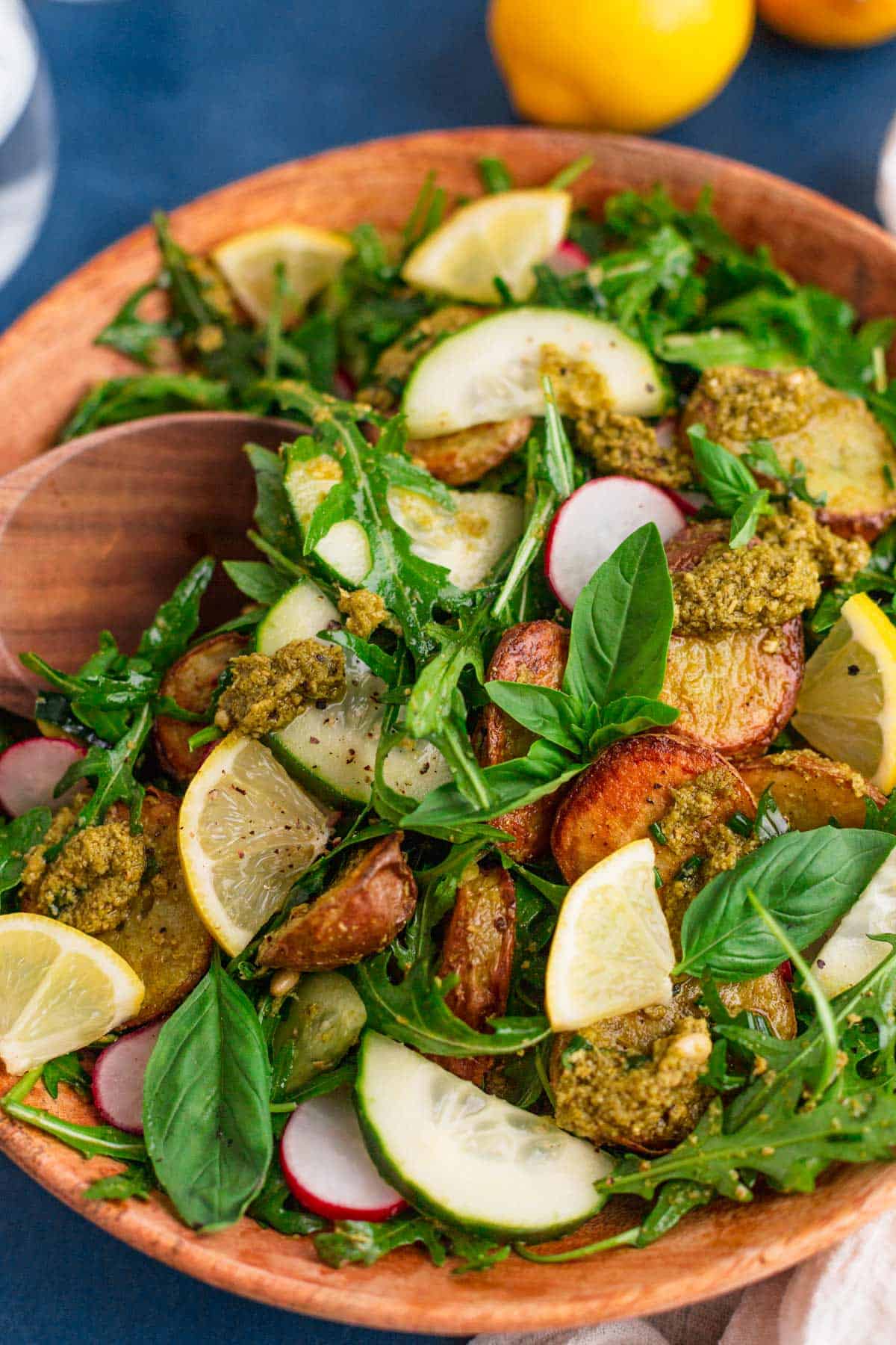 pesto potato salad in a wooden bowl