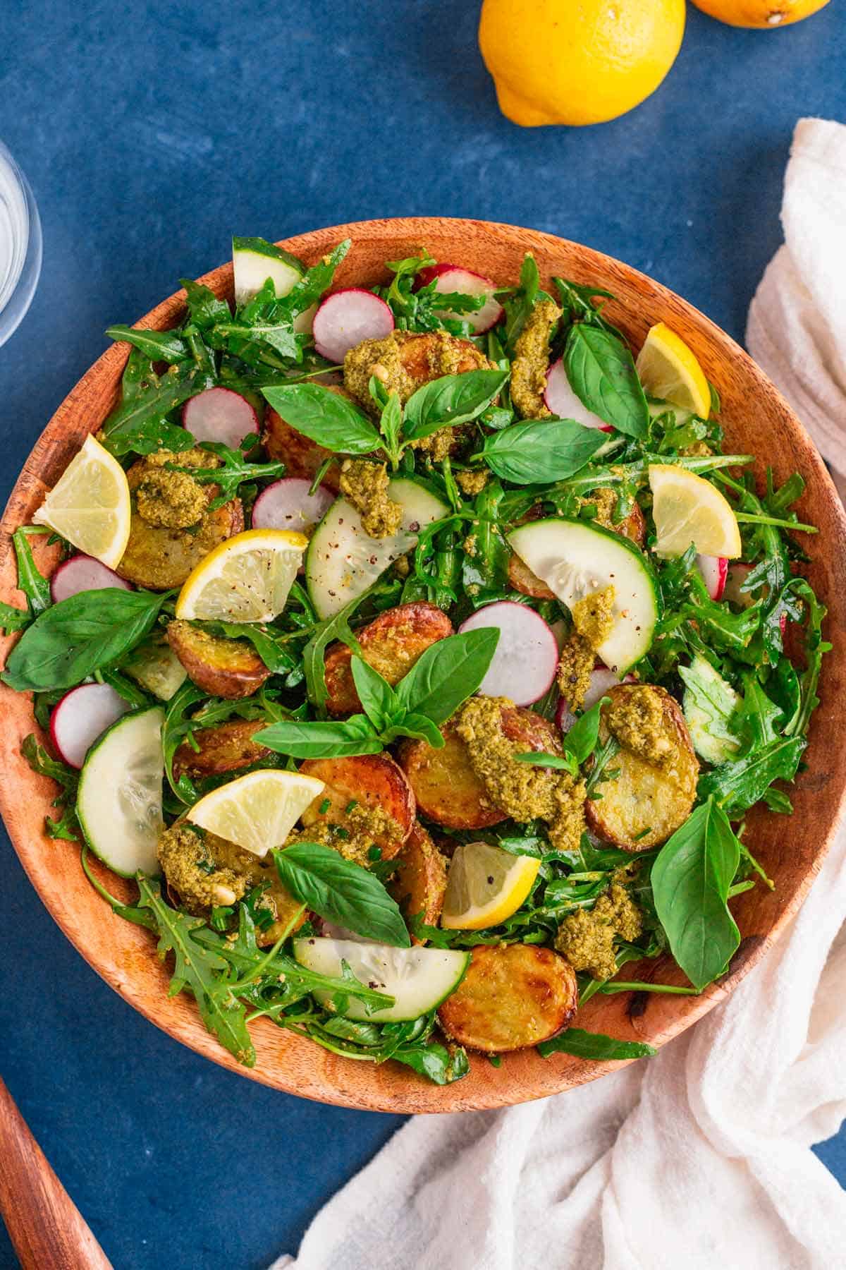 pesto potato salad in a wooden bowl