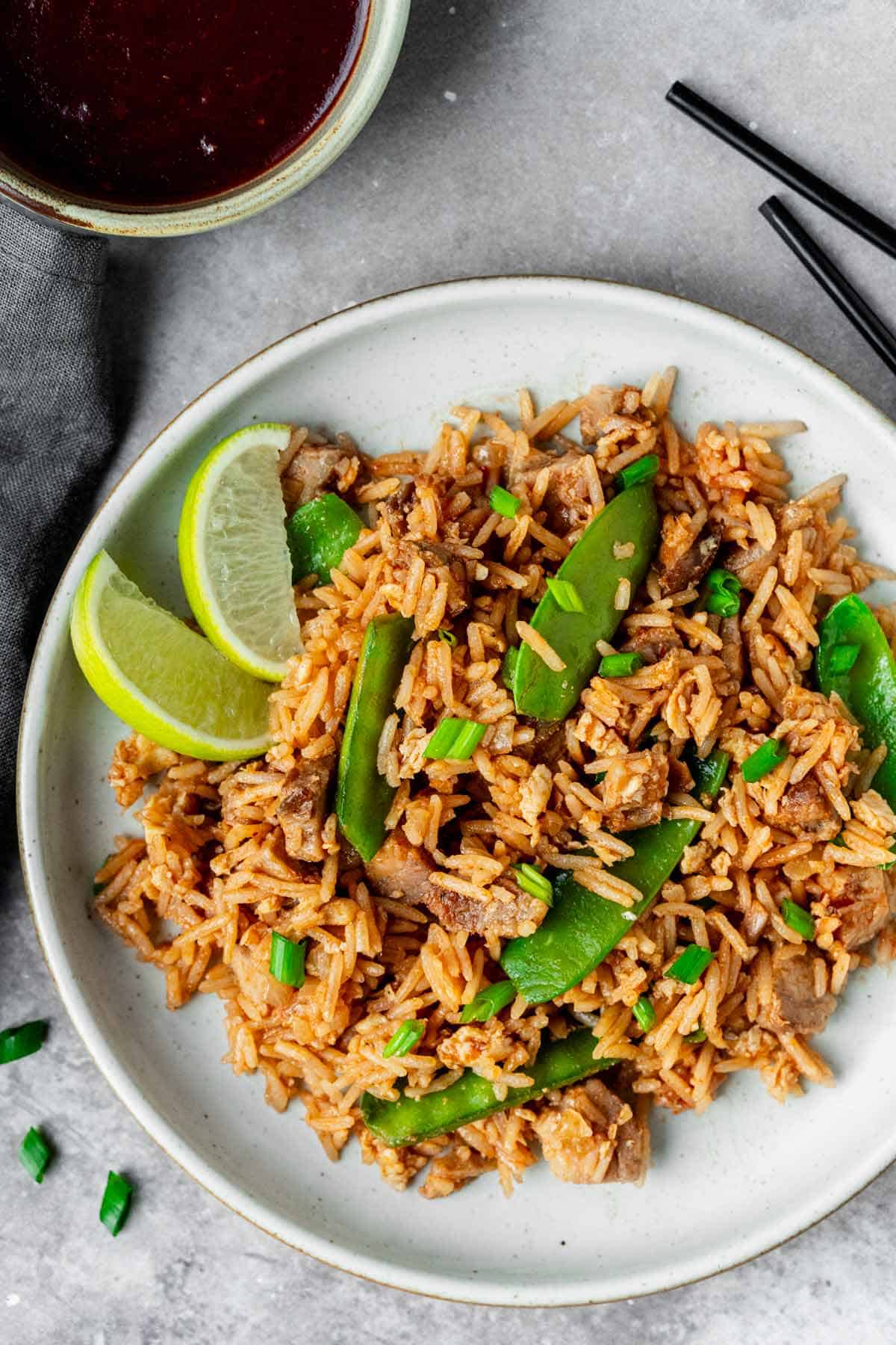 bbq pork fried rice in a white bowl with chopsticks