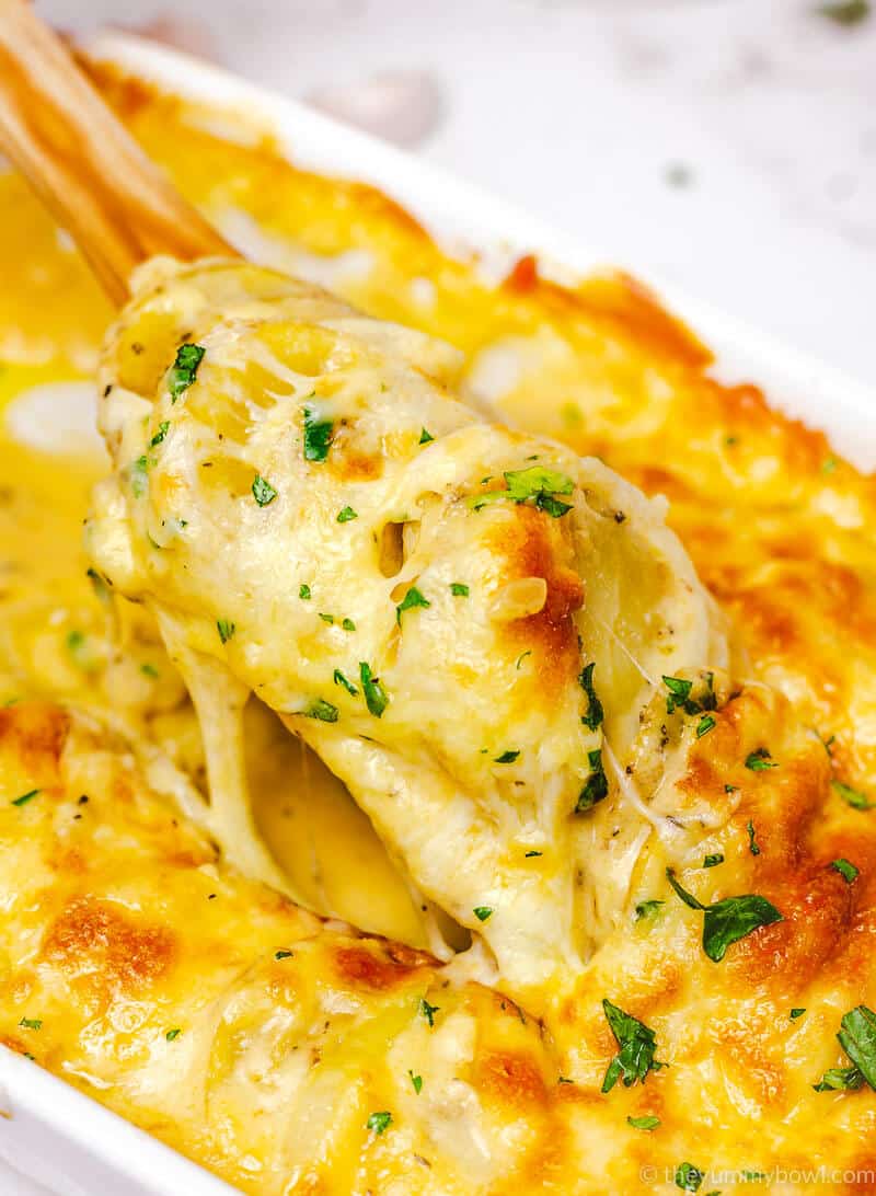 cheesy and creamy potato au gratin in a white rectangular baking dish