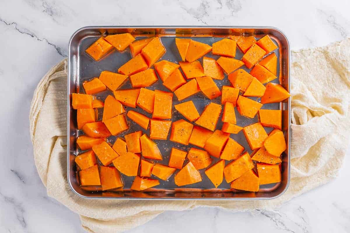 pumpkin chunks before roasting on a metal baking tray