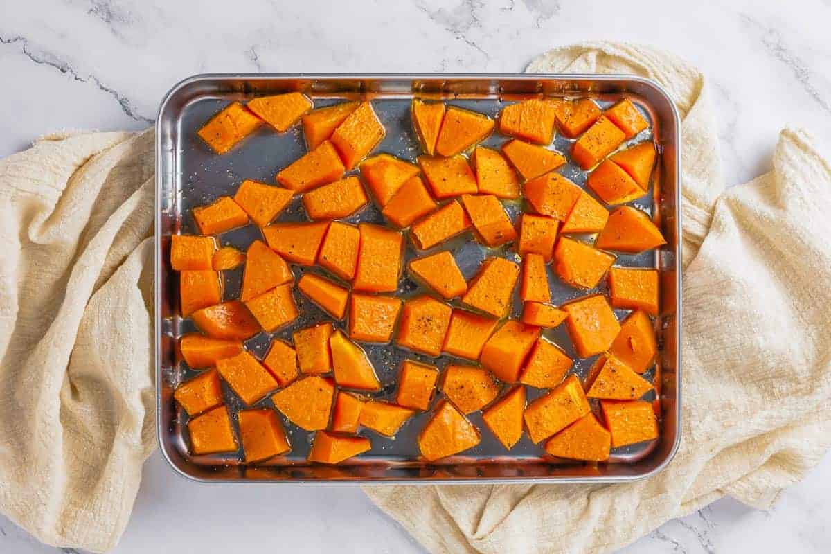 roasted pumpkin chunks after roasting on a metal baking tray