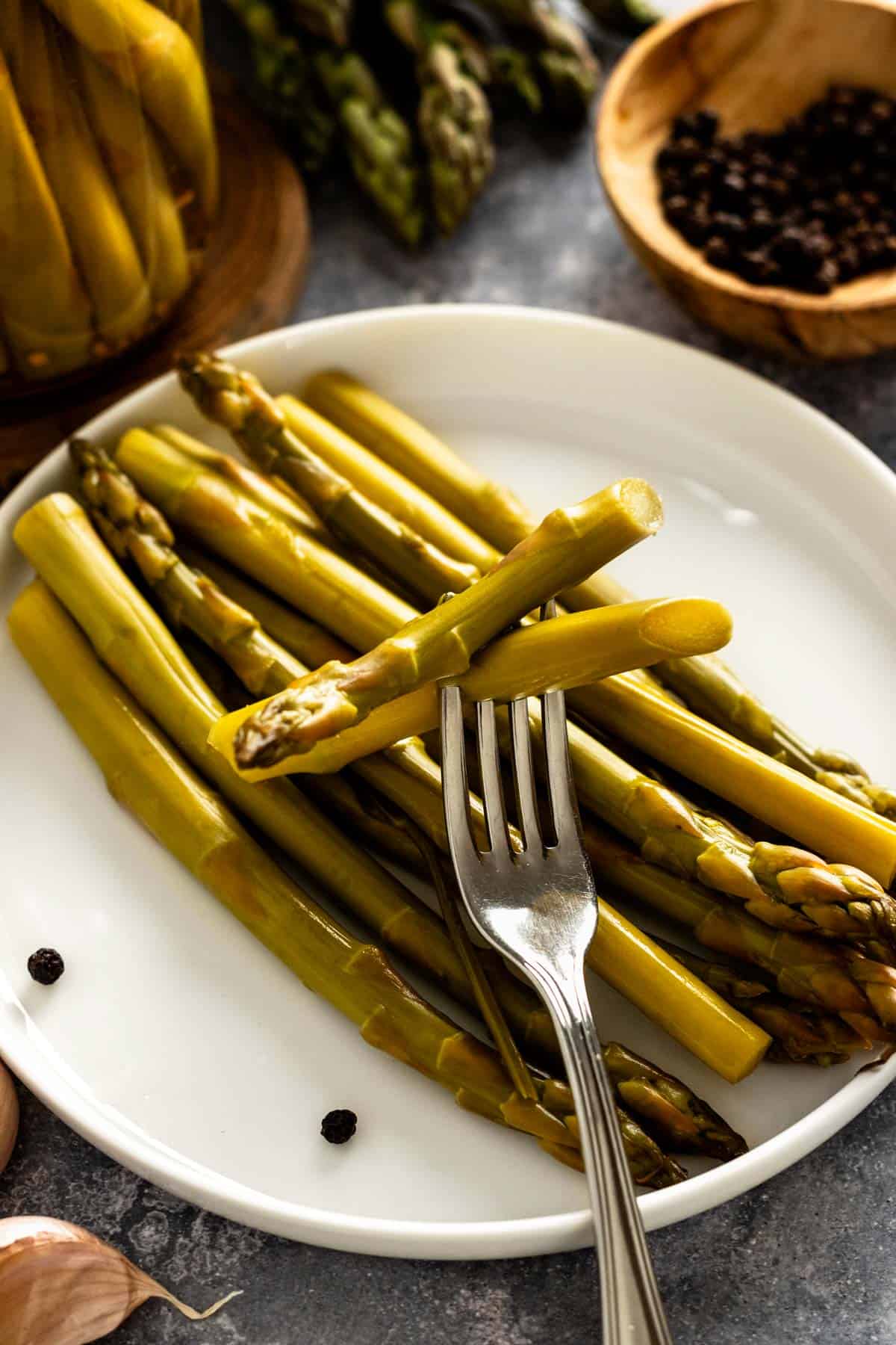 pickled asparagus spears on a plate.