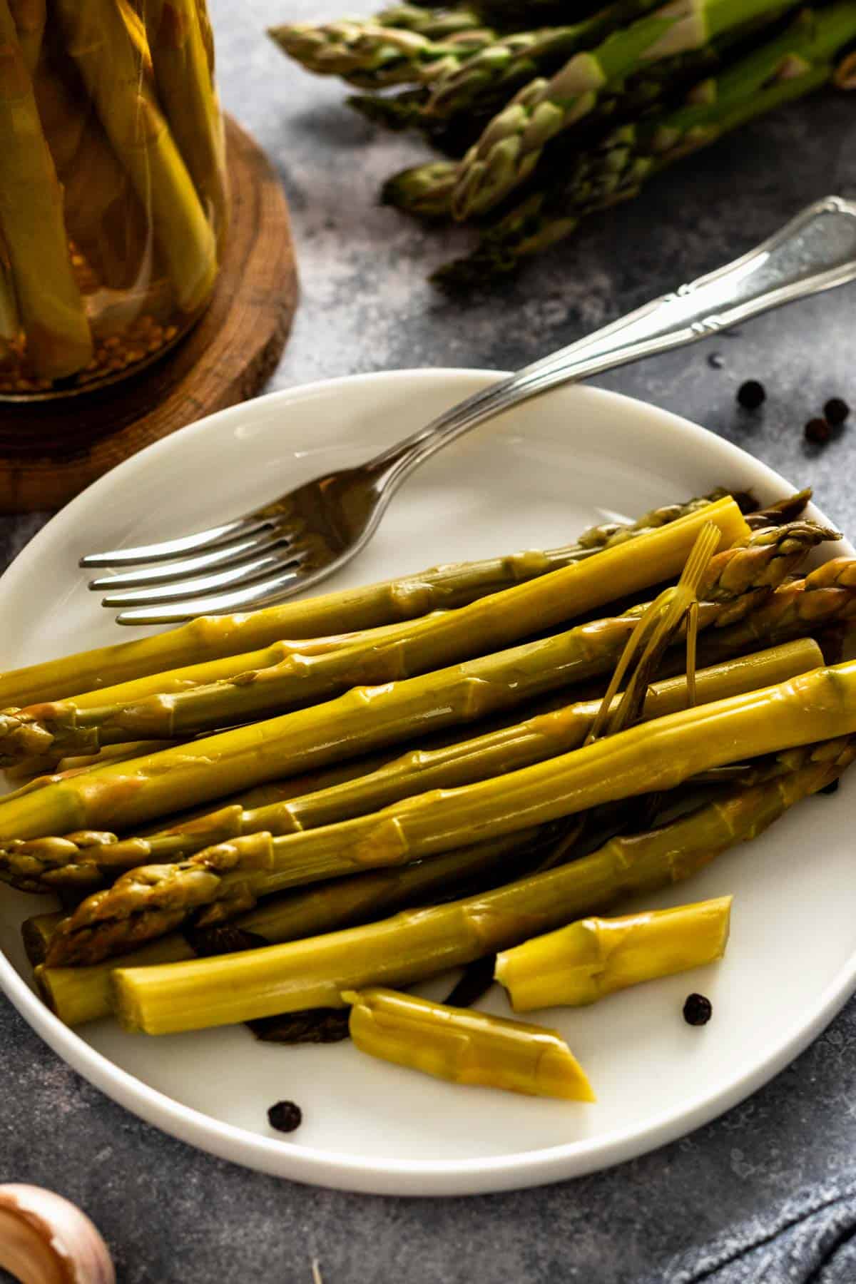 pickled asparagus spears on a plate.