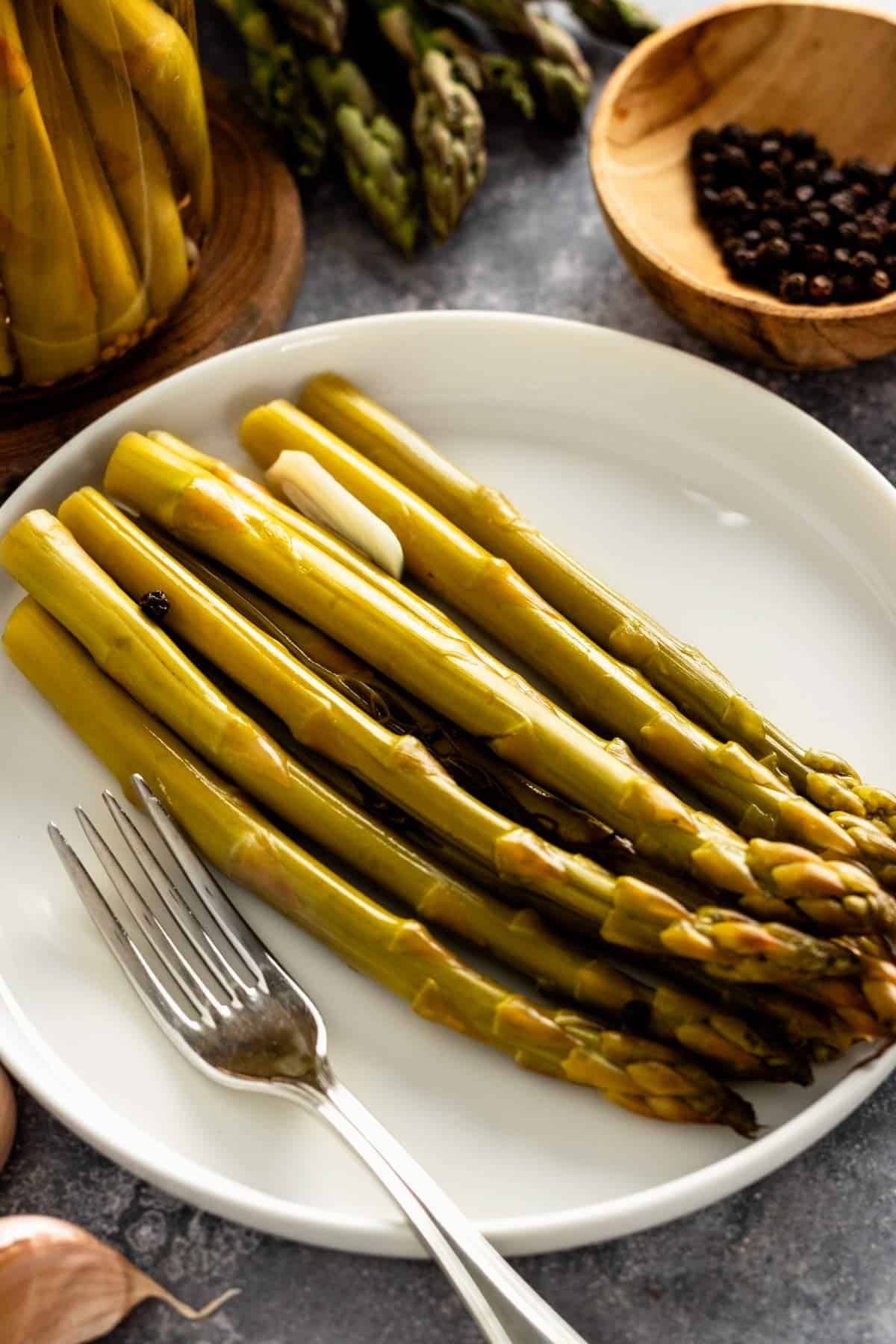 pickled asparagus spears on a plate.